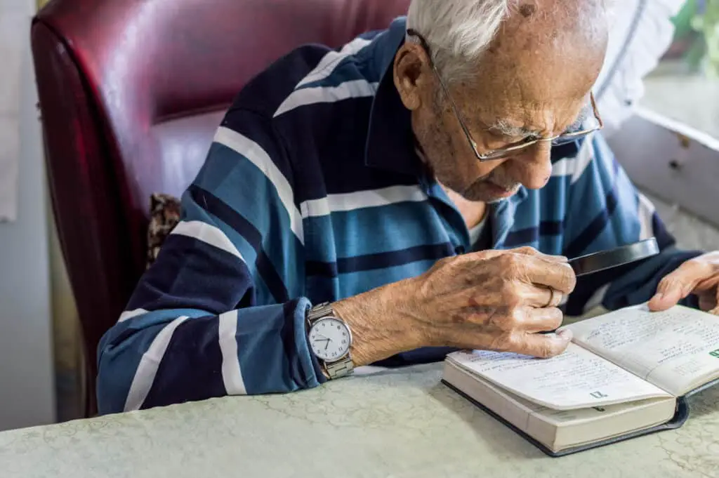 Senior with magnifying glass